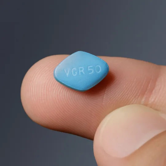 a Viagra pill on a finger tip