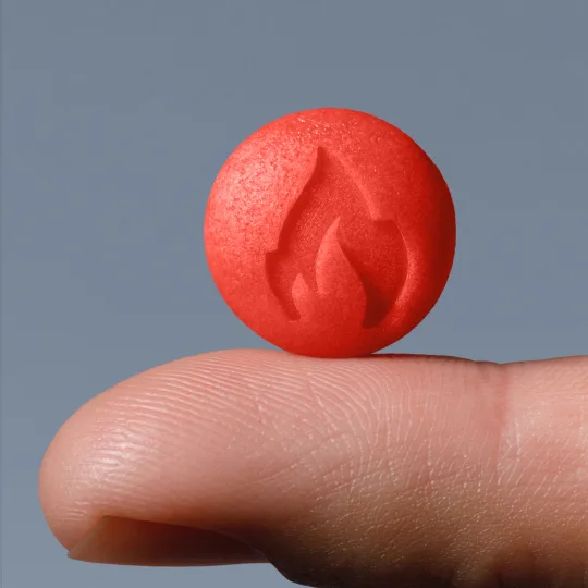 a Ro Sparks sublingual drop standing on a finger