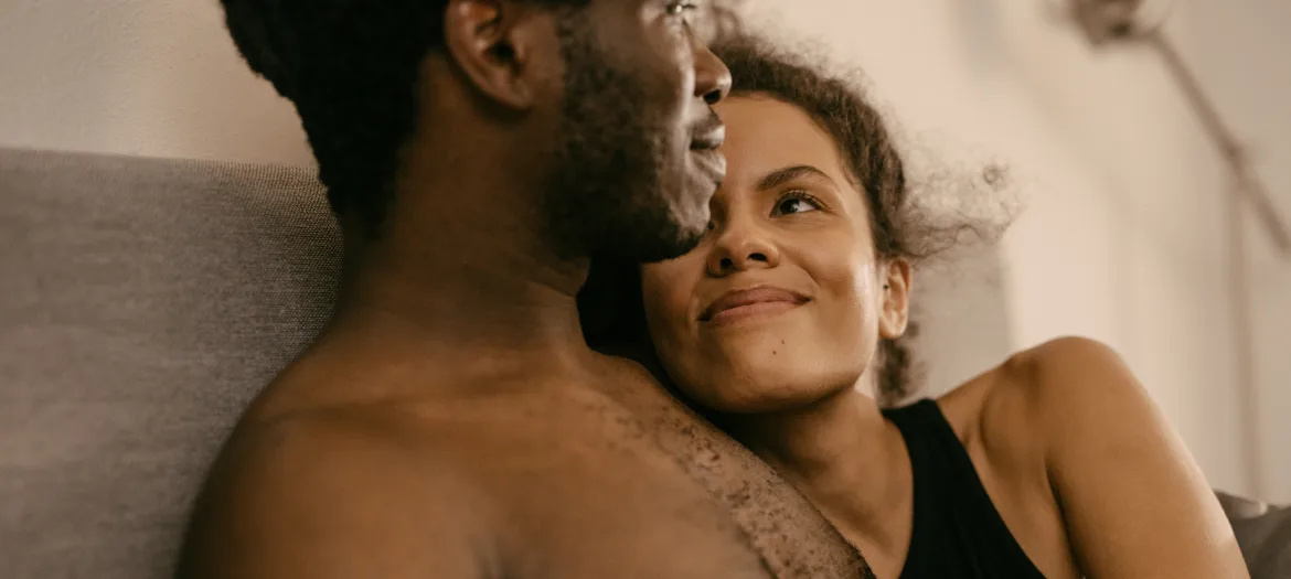 a couple laughing in bed