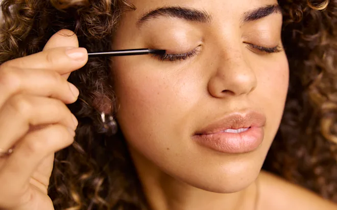 woman using Latisse on her eyelashes